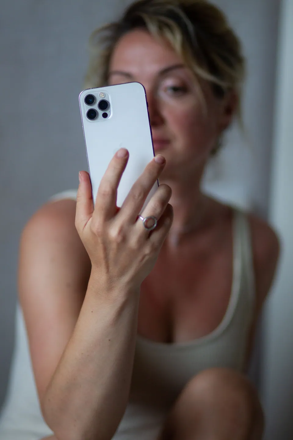 Woman holding a phone in front of her face for a selfie