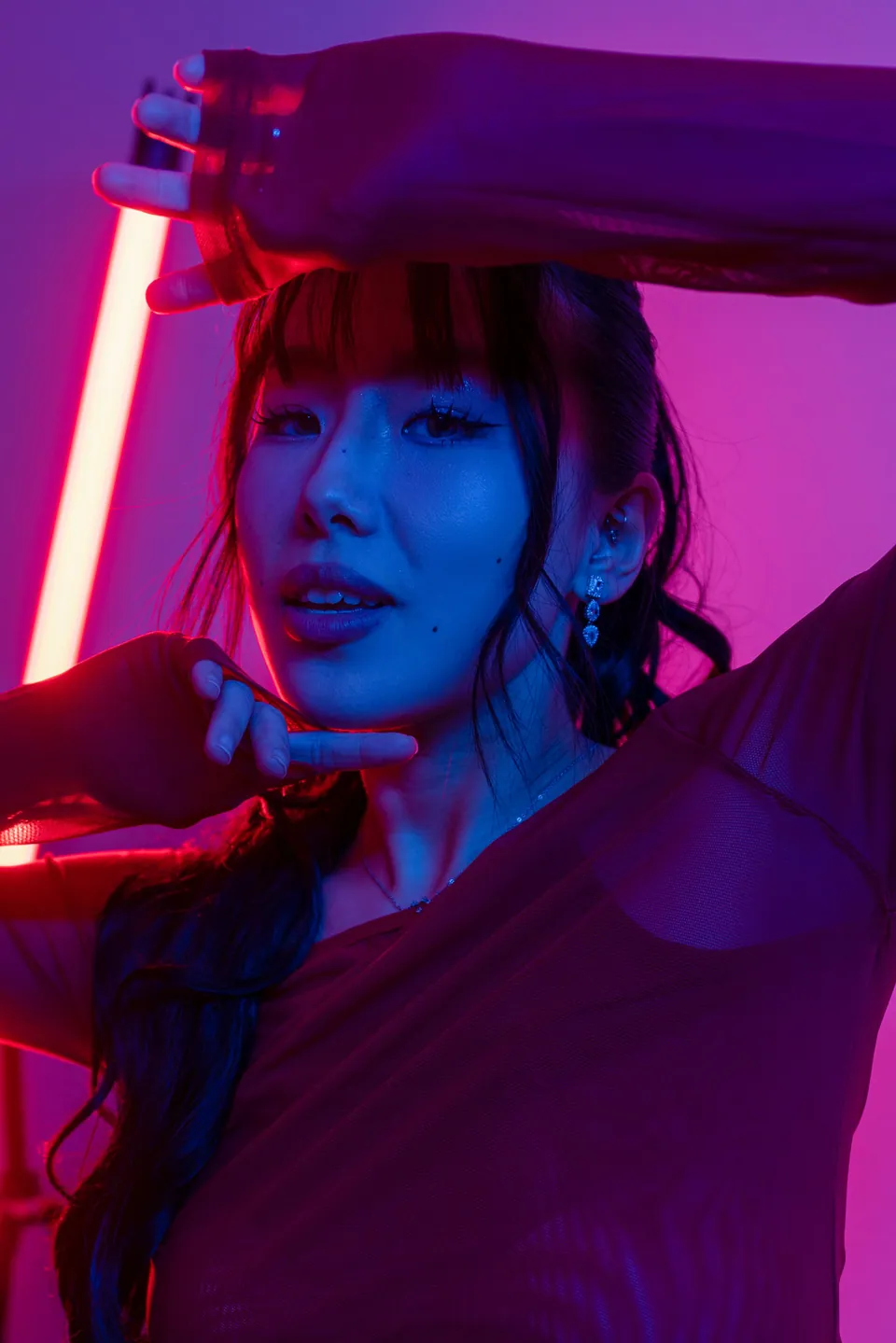 Portrait lit by contrasting blue and pink lights