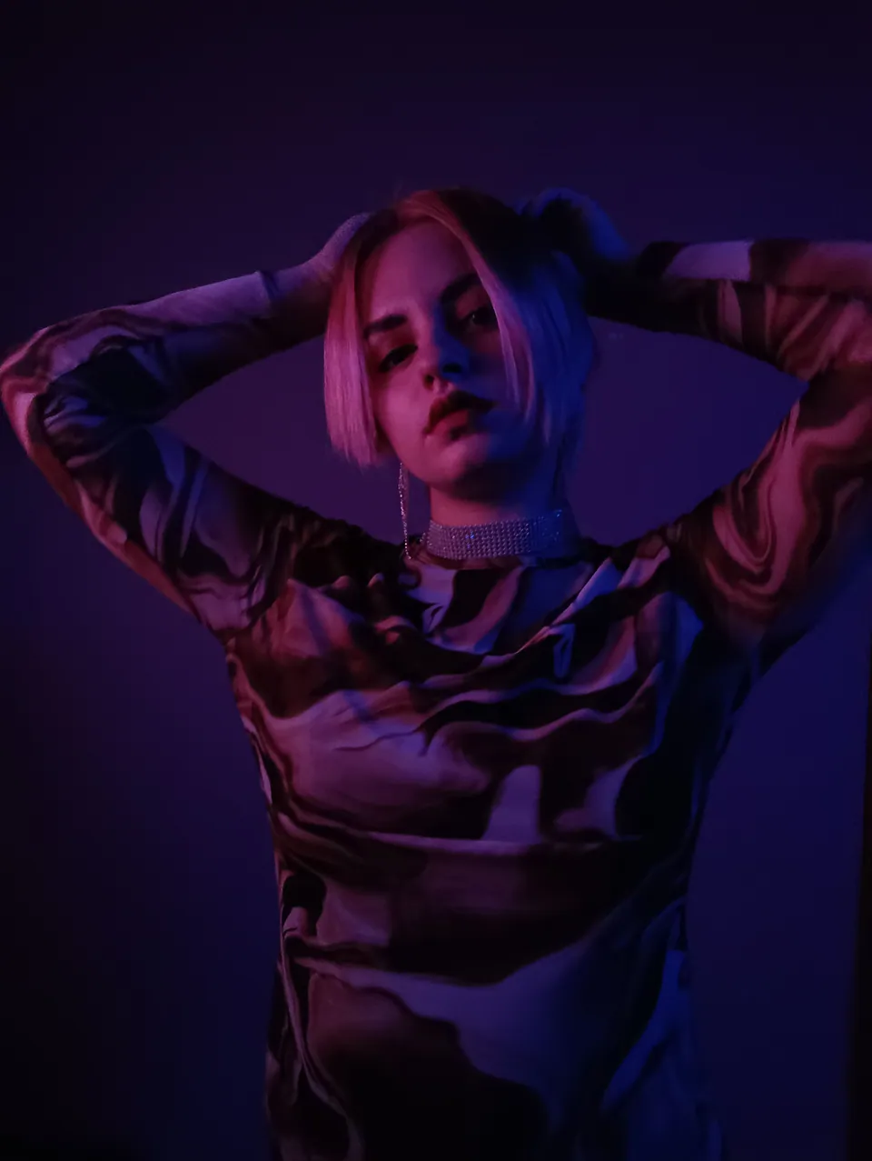 Portrait of a woman under purple and pink lighting